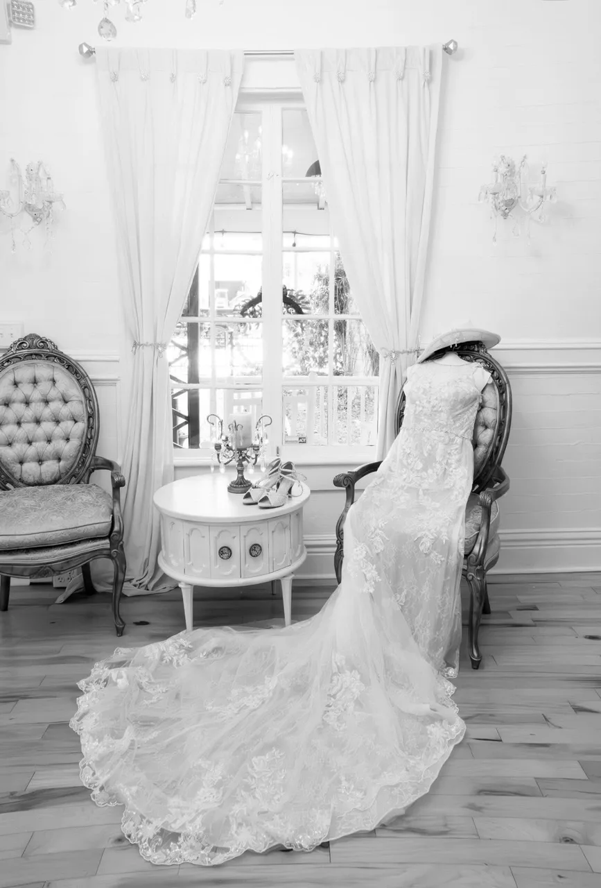Wedding dress draped over a vintage chair
