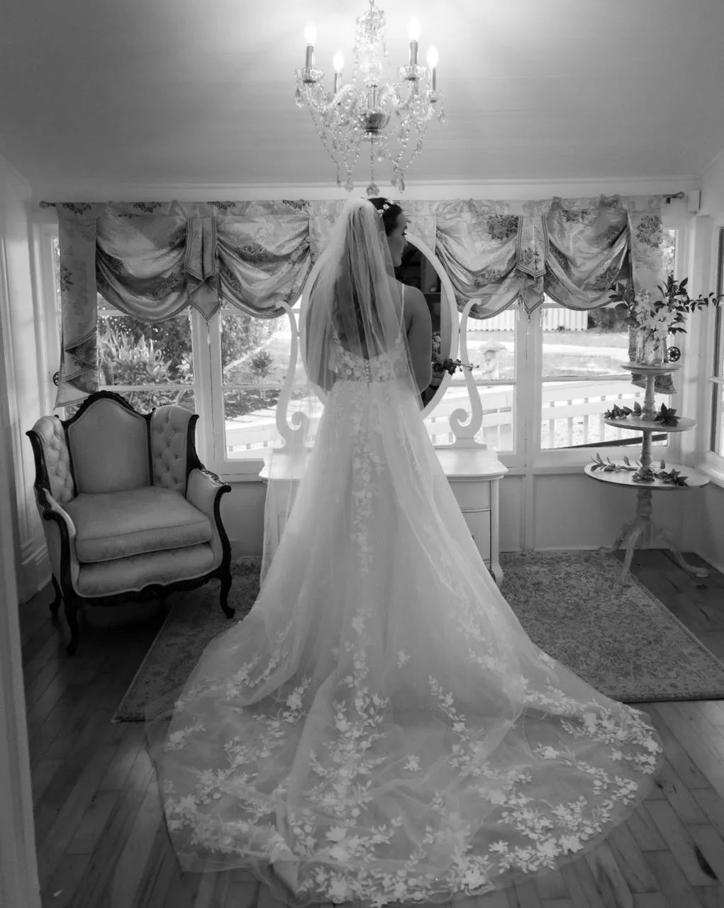 Bride preparing for her special day with chandelier in background